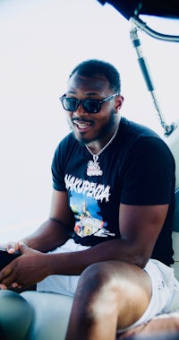 a man wearing sunglasses sitting on a boat