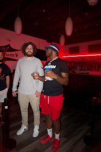 a group of men standing in a bar